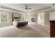 Expansive primary bedroom boasts a fireplace, trey ceiling, and ample natural light at 3198 Garden Hill Ln, Douglasville, GA 30135