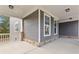 Inviting covered porch with stone accents and neutral siding showcases outdoor living space at 3198 Garden Hill Ln, Douglasville, GA 30135