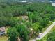 Aerial view of property surrounded by trees with road access at 35 Cornish Creek Ln, Covington, GA 30014