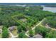 Aerial view of wooded property shows boundaries with lake in background at 35 Cornish Creek Ln, Covington, GA 30014