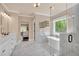 Spa-like bathroom features a large glass shower, soaking tub, dual sinks and marble floors at 35 Cornish Creek Ln, Covington, GA 30014