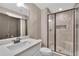 Well-lit bathroom features tiled shower with glass door, quartz countertop, and modern fixtures at 35 Cornish Creek Ln, Covington, GA 30014