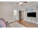 Bedroom with hardwood floors, TV, and access to a bathroom and hallway at 35 Cornish Creek Ln, Covington, GA 30014