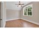 Bright bedroom features hardwood floors, a ceiling fan, and a large window offering natural light at 35 Cornish Creek Ln, Covington, GA 30014