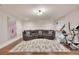 Spacious bonus room with sectional couch and exercise equipment on hardwood floor at 35 Cornish Creek Ln, Covington, GA 30014