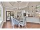 Open dining room with view into the kitchen and sunroom at 35 Cornish Creek Ln, Covington, GA 30014