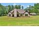 Beautiful home with manicured lawn, stone accents, and a detached garage at 35 Cornish Creek Ln, Covington, GA 30014