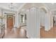 Elegant foyer with hardwood floors, decorative columns, and a wooden front door at 35 Cornish Creek Ln, Covington, GA 30014