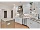 This bright kitchen offers white cabinets, stainless steel appliances and granite countertops at 35 Cornish Creek Ln, Covington, GA 30014
