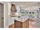 Bright kitchen features white cabinets, stainless steel appliances, granite countertops and a center island at 35 Cornish Creek Ln, Covington, GA 30014