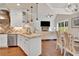 Open kitchen features white cabinets, stainless steel appliances, granite countertops and opens to the living room at 35 Cornish Creek Ln, Covington, GA 30014