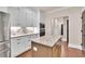 Bright kitchen with white cabinets, stainless steel appliances and a center island at 35 Cornish Creek Ln, Covington, GA 30014
