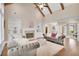 Elegant living room with a fireplace, built-in shelving, hardwood floors, and luxurious sofas at 35 Cornish Creek Ln, Covington, GA 30014