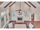 Bright living room boasts wood beams, fireplace, built-in shelving, and comfortable seating at 35 Cornish Creek Ln, Covington, GA 30014