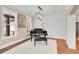 Bright living room featuring a piano, hardwood flooring, and large windows at 35 Cornish Creek Ln, Covington, GA 30014