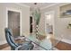 Office space features a glass desk, comfortable executive chair, and dark accent doors at 35 Cornish Creek Ln, Covington, GA 30014