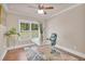 Bright office space with decorative rug, glass-top desk, and large window for natural light at 35 Cornish Creek Ln, Covington, GA 30014