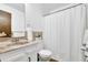 Bathroom featuring a marble countertop vanity, modern fixtures, and a shower with a white curtain at 102 Bascomb Drive Dr, Woodstock, GA 30189