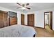 Bedroom featuring a ceiling fan, wood closet doors, and a connected bathroom for added convenience at 102 Bascomb Drive Dr, Woodstock, GA 30189