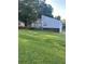 Charming home featuring a deck and well-maintained front yard with lots of grass and mature trees at 102 Bascomb Drive Dr, Woodstock, GA 30189
