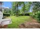 Landscaped backyard with a brick patio and mature trees at 2702 Galaxy Ct, Decatur, GA 30034