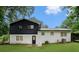Spacious backyard featuring manicured lawn, freshly painted white brick and dark wood at 2702 Galaxy Ct, Decatur, GA 30034