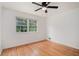 Well-lit bedroom showcasing hardwood floors, a ceiling fan, and a bright window at 2702 Galaxy Ct, Decatur, GA 30034