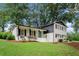 Charming two-story home featuring a manicured lawn, fresh white paint, and contrasting black trim at 2702 Galaxy Ct, Decatur, GA 30034