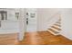 Inviting foyer seamlessly connecting to a bright kitchen with white marble floors and a staircase at 2702 Galaxy Ct, Decatur, GA 30034
