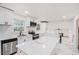 Well-lit open kitchen boasting an island, white cabinets, stainless steel appliances, and tiled backsplash at 2702 Galaxy Ct, Decatur, GA 30034