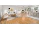 Sunlit living area featuring modern decor with hardwood floors, and an open layout to the kitchen and dining area at 2702 Galaxy Ct, Decatur, GA 30034