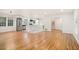 Spacious open layout featuring kitchen, stairs, and dining area with gleaming hardwood floors and ample natural light at 2702 Galaxy Ct, Decatur, GA 30034