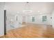 Bright open layout connecting a modern kitchen to a large, versatile living space with beautiful hardwood floors at 2702 Galaxy Ct, Decatur, GA 30034