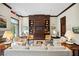 Elegant living room with a fireplace, built-in shelving, and comfortable seating at 2795 Peachtree Ne Rd # 703, Atlanta, GA 30305