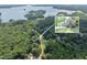 Aerial view of a lakeside home surrounded by lush greenery with lake views and neighborhood view at 3365 Sweetwater Dr, Cumming, GA 30041