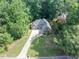 An aerial view shows a beautiful home with lush landscaping and long driveway at 3365 Sweetwater Dr, Cumming, GA 30041