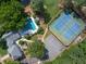 Aerial view showcasing the pool and tennis court amenities surrounded by lush greenery at 3365 Sweetwater Dr, Cumming, GA 30041