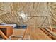 Finished attic space with foam insulation, platform bed, and cozy lighting at 3365 Sweetwater Dr, Cumming, GA 30041