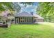 Well-maintained backyard with a spacious lawn and an enclosed sunroom at 3365 Sweetwater Dr, Cumming, GA 30041