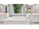 Elegant bathroom featuring a deep soaking tub and a wide window, perfect for relaxation and natural light at 3365 Sweetwater Dr, Cumming, GA 30041