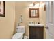 This charming bathroom features a dark wood vanity and decorative framed mirror at 3365 Sweetwater Dr, Cumming, GA 30041
