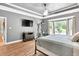 Bedroom with bay window providing natural light, complemented by a TV and exercise equipment for convenience at 3365 Sweetwater Dr, Cumming, GA 30041