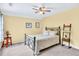 Bedroom with yellow walls, ceiling fan, and a bed at 3365 Sweetwater Dr, Cumming, GA 30041