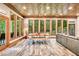 Bright dining room featuring hardwood floors, exposed beam ceiling, and multiple windows with a view of the outdoors at 3365 Sweetwater Dr, Cumming, GA 30041