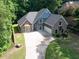 A landscaped front exterior view of a two-story home with manicured lawn at 3365 Sweetwater Dr, Cumming, GA 30041