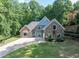 Beautiful two-story home featuring stone accents, manicured landscaping, and a spacious driveway at 3365 Sweetwater Dr, Cumming, GA 30041