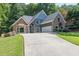 Inviting two-story home with stone accents, blue siding, lush lawn, and convenient two-car garage at 3365 Sweetwater Dr, Cumming, GA 30041