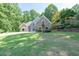 Charming home with stone and blue siding, complemented by a well-manicured lawn and landscaped hillside at 3365 Sweetwater Dr, Cumming, GA 30041