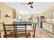 Kitchen with island cooktop, stainless refrigerator, breakfast bar, and wood tile floors at 3365 Sweetwater Dr, Cumming, GA 30041