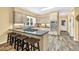 Bright kitchen featuring granite counters, island stovetop, stainless appliances, and tile flooring at 3365 Sweetwater Dr, Cumming, GA 30041